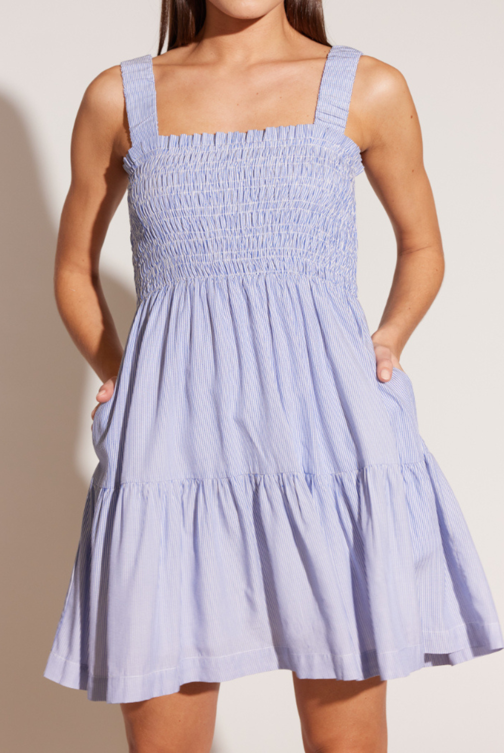 Model wearing the stripey Amara Shirred mini dress