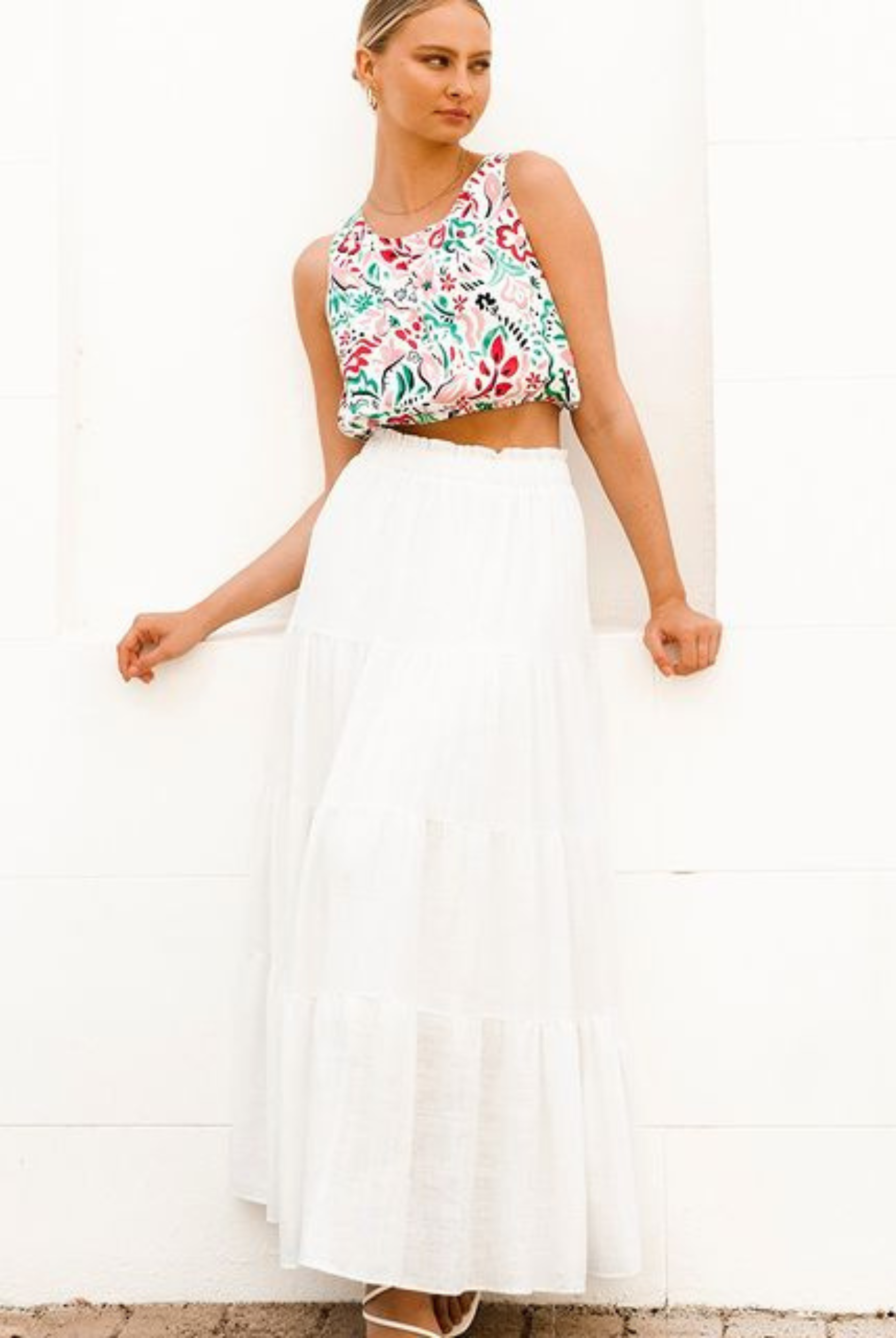 Model wearing a tiered off white maxi skirt with elasticated waistband