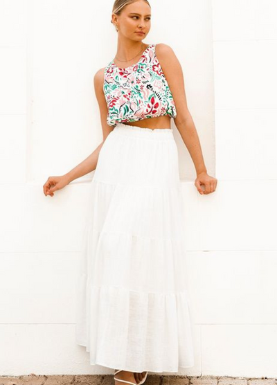 Model wearing a tiered off white maxi skirt with elasticated waistband