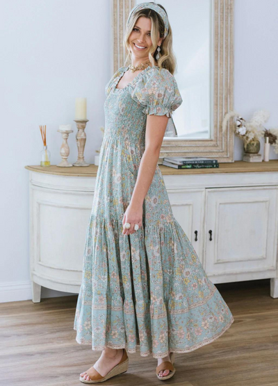 Model wearing the house of skye Daisy Belle dress in floral print with shirred bust and puff sleeve
