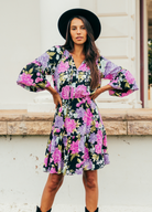 Model wearing the tarni mini dress in floral print