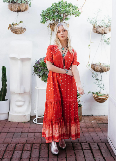 Model wearing a red boho maxi dress with border print at the bottom