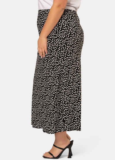 Model wearing the black and white spot print midi skirt in viscose crepe