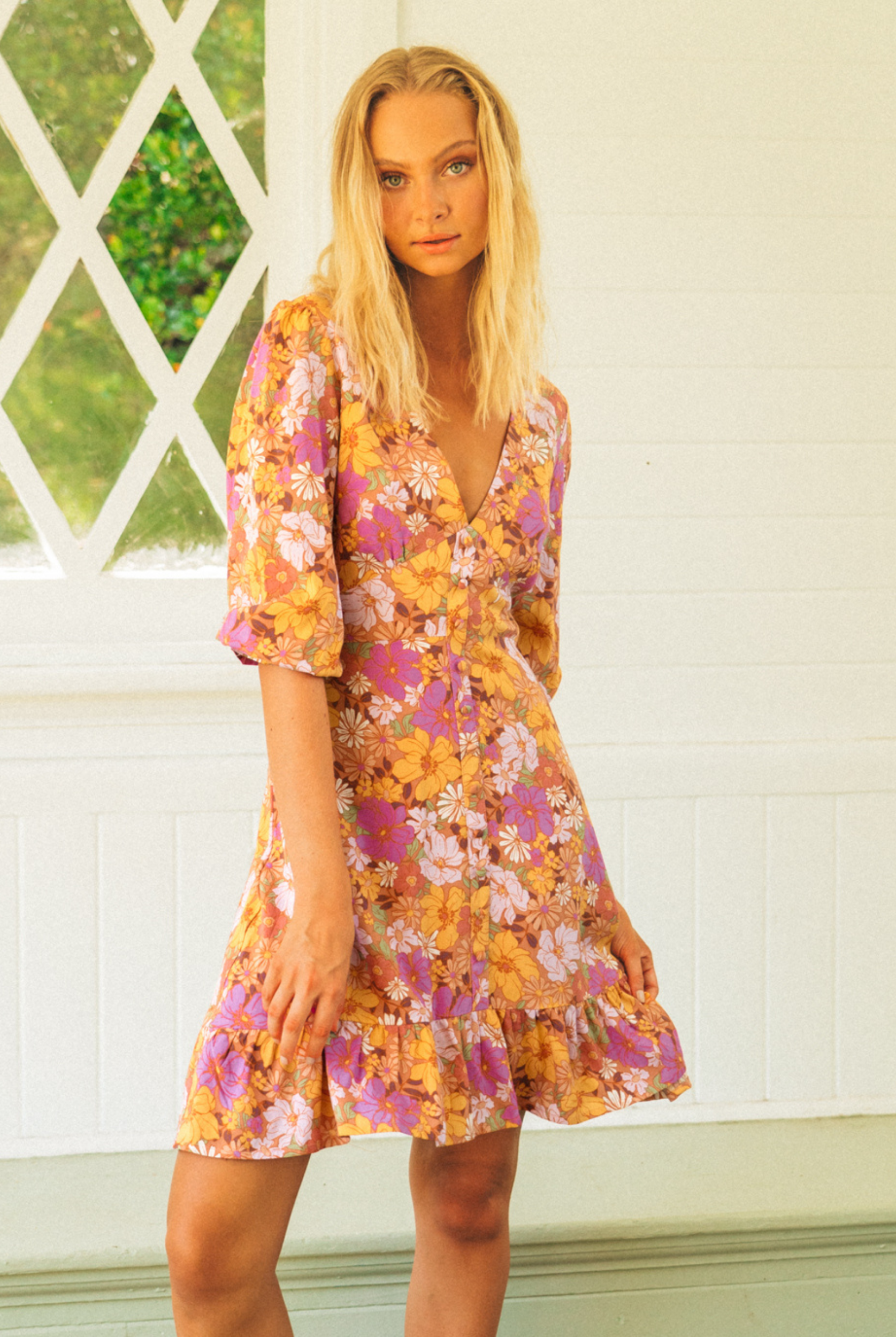 Floral Mini Dress with button detail at front, mid sleeves and a ruffle at the hemline.