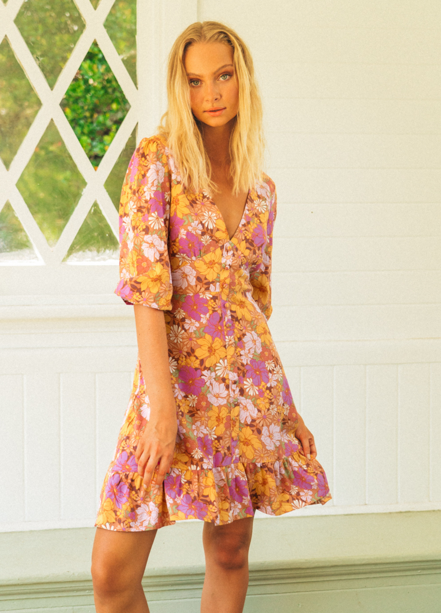 Floral Mini Dress with button detail at front, mid sleeves and a ruffle at the hemline.