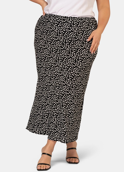 Model wearing the black and white spot print midi skirt in viscose crepe