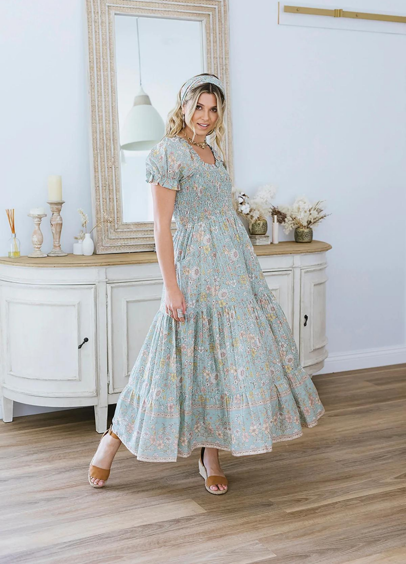 Model wearing the house of skye Daisy Belle dress in floral print with shirred bust and puff sleeve