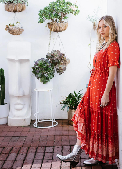 Model wearing a red boho maxi dress with border print at the bottom