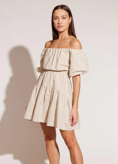 Model wearing the Isola beige off shoulder linen dress with a line hem