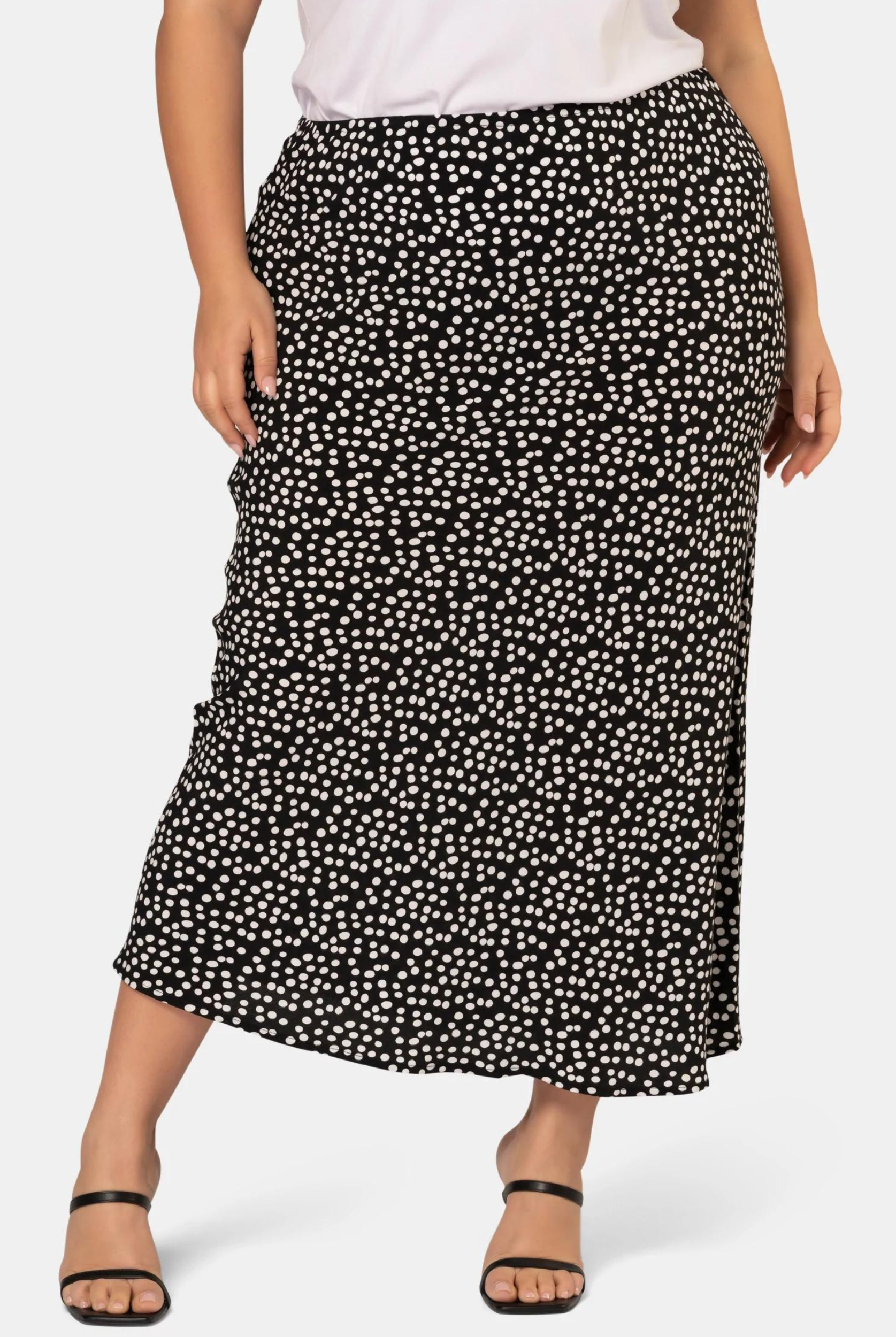 Model wearing the black and white spot print midi skirt in viscose crepe