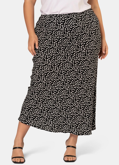 Model wearing the black and white spot print midi skirt in viscose crepe