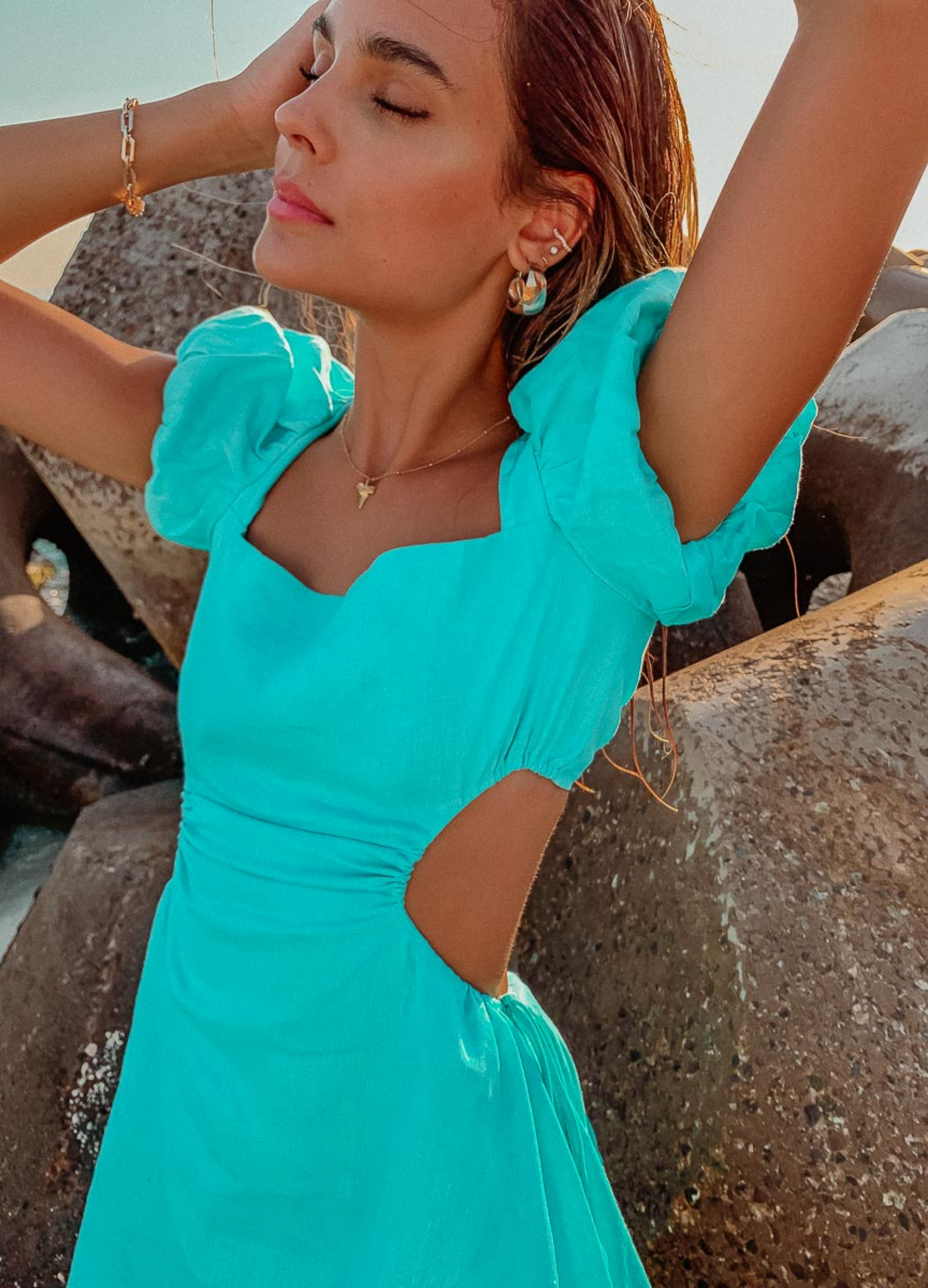 Brunette model wearing the arametta dress in aqua