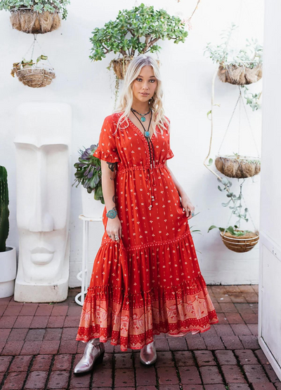 Model wearing a red boho maxi dress with border print at the bottom