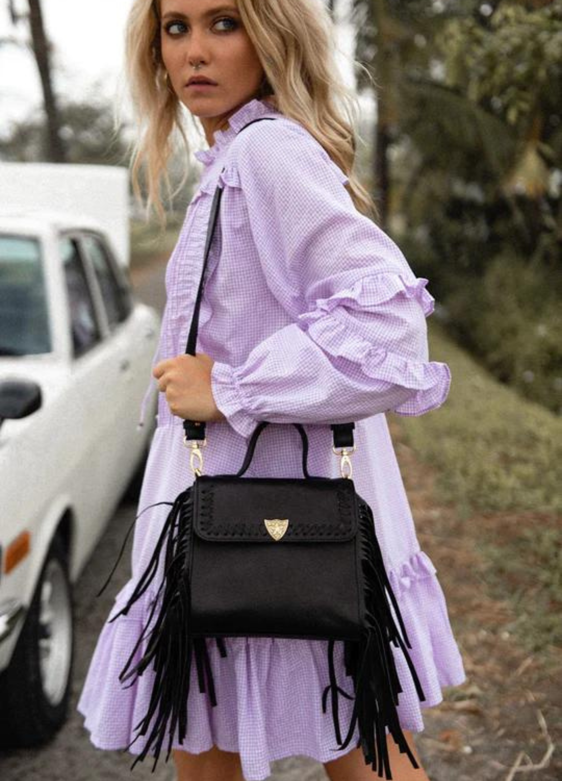 Model wearing the Innerbloom back with a purple smock dress and smokey eyes