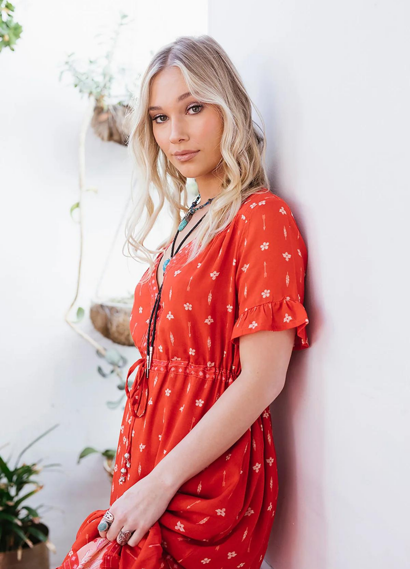 Model wearing a red boho maxi dress with border print at the bottom