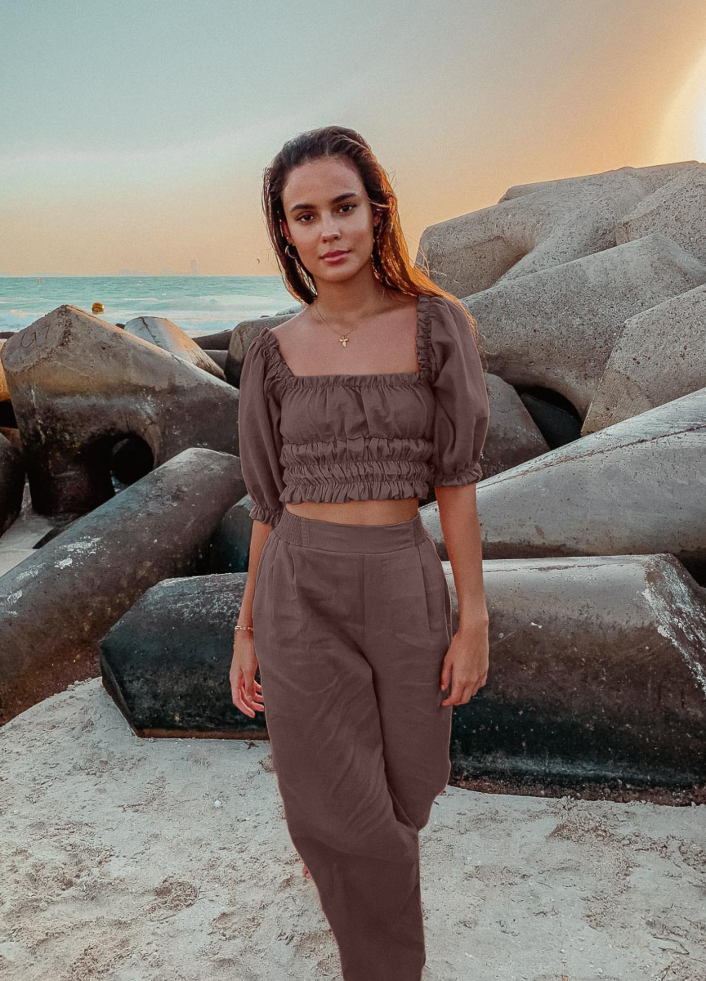 Model wearing chocolate linen shirred off the shoulder top with matching chocolate linen pants