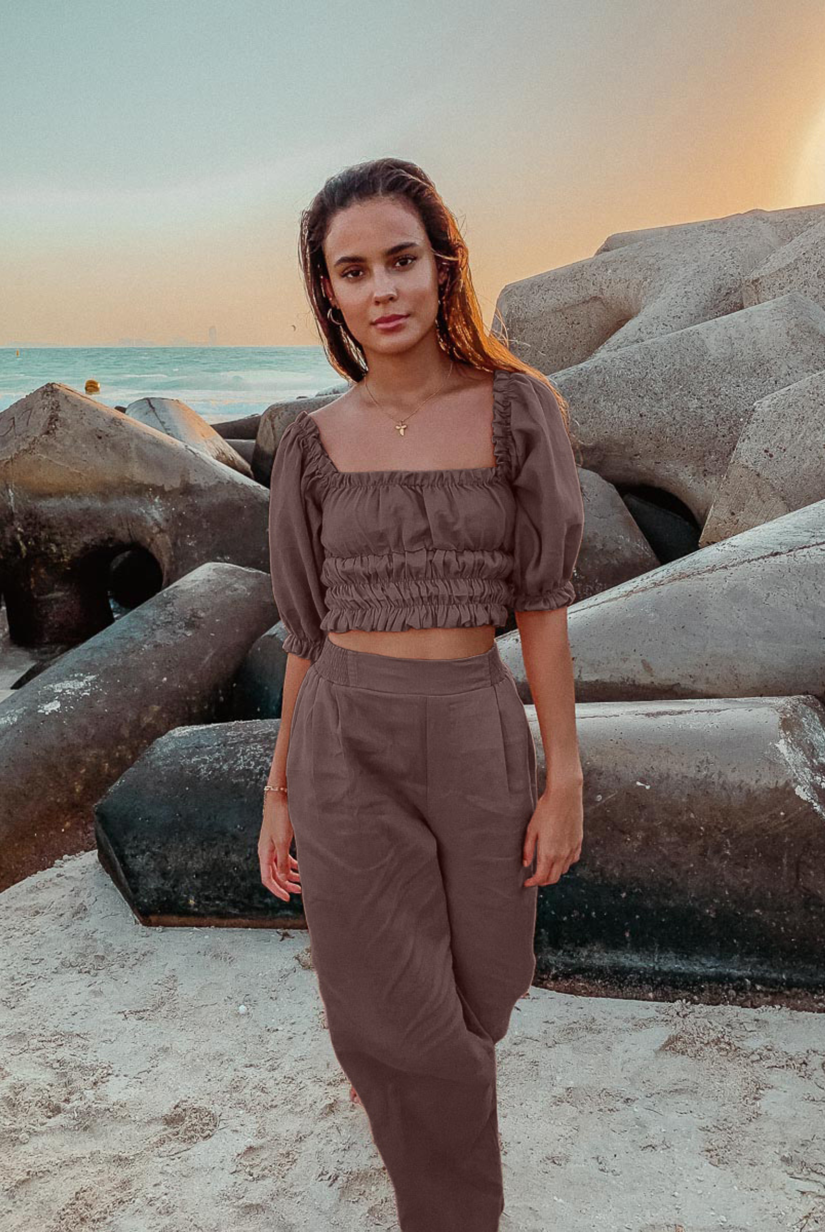 Woman wearing chocolate brown Zoe top with shirring and puff sleeves with co-ordinating poolside linen pant