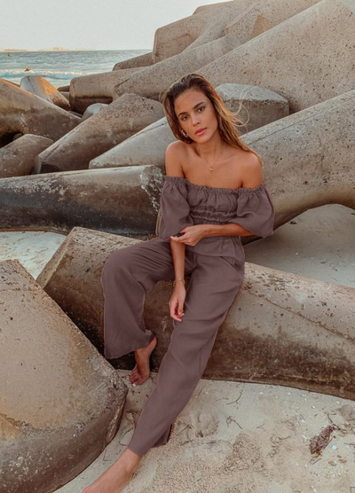 Model wearing chocolate linen shirred off the shoulder top with matching chocolate linen pants