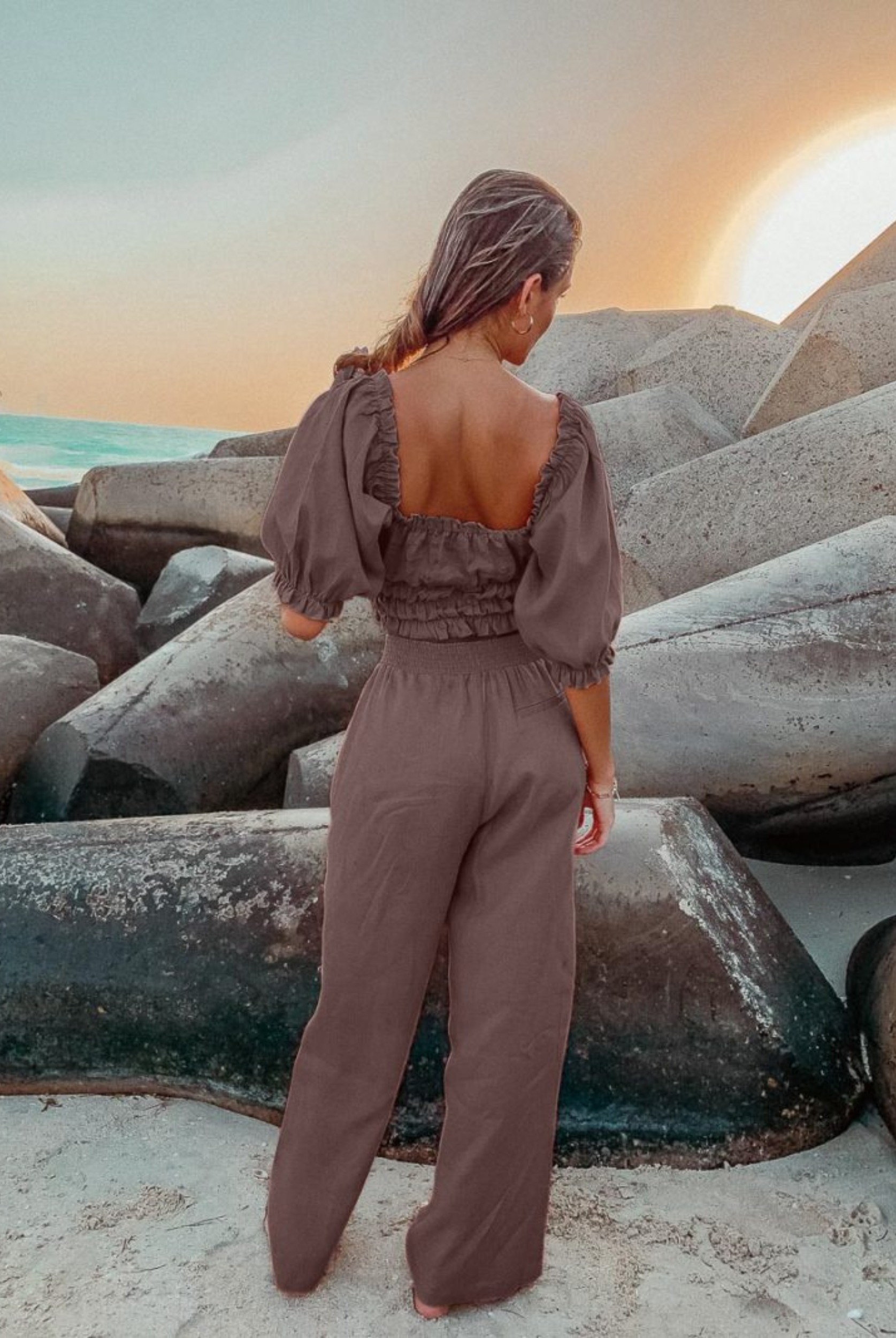 Model wearing chocolate linen shirred off the shoulder top with matching chocolate linen pants