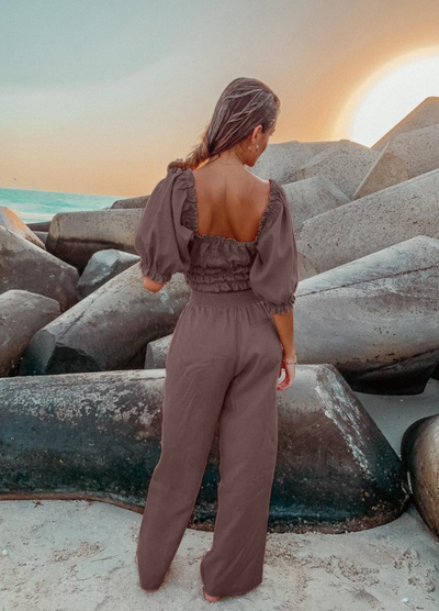 Model wearing chocolate linen shirred off the shoulder top with matching chocolate linen pants