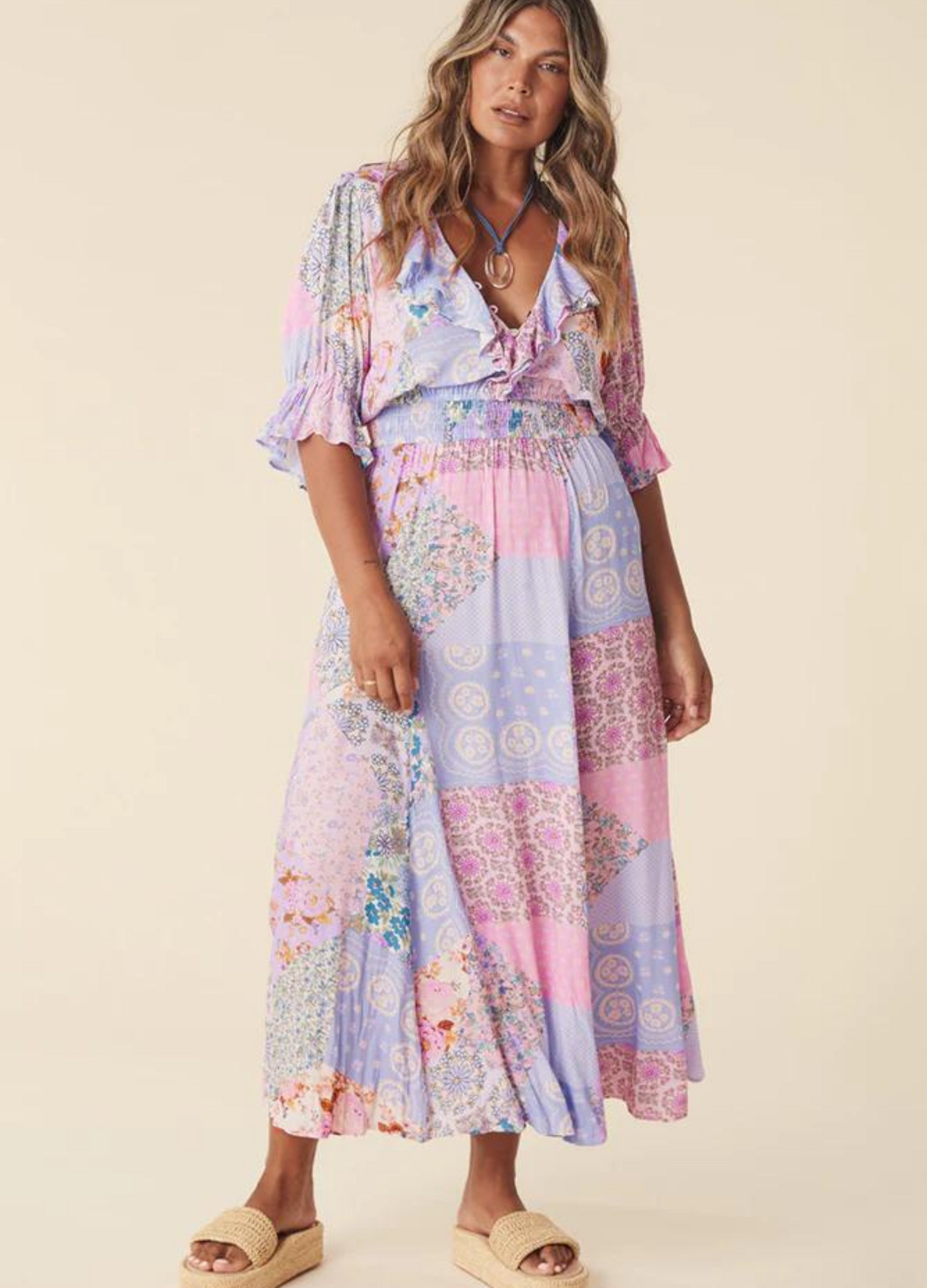 Model wearing the pastel print jacaranda gown from Spell (cha cha collection) 