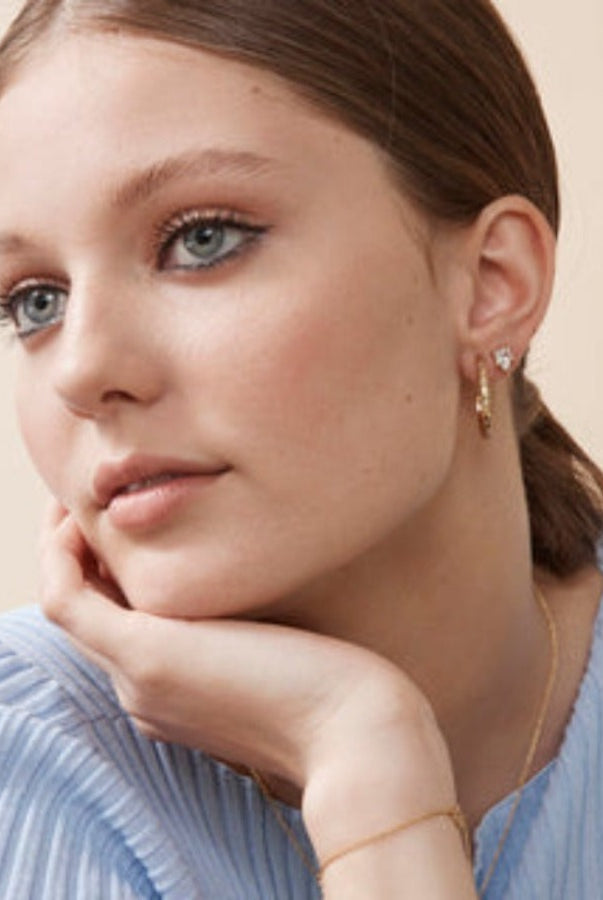 Model wearing the Alva studs with a blue sweater