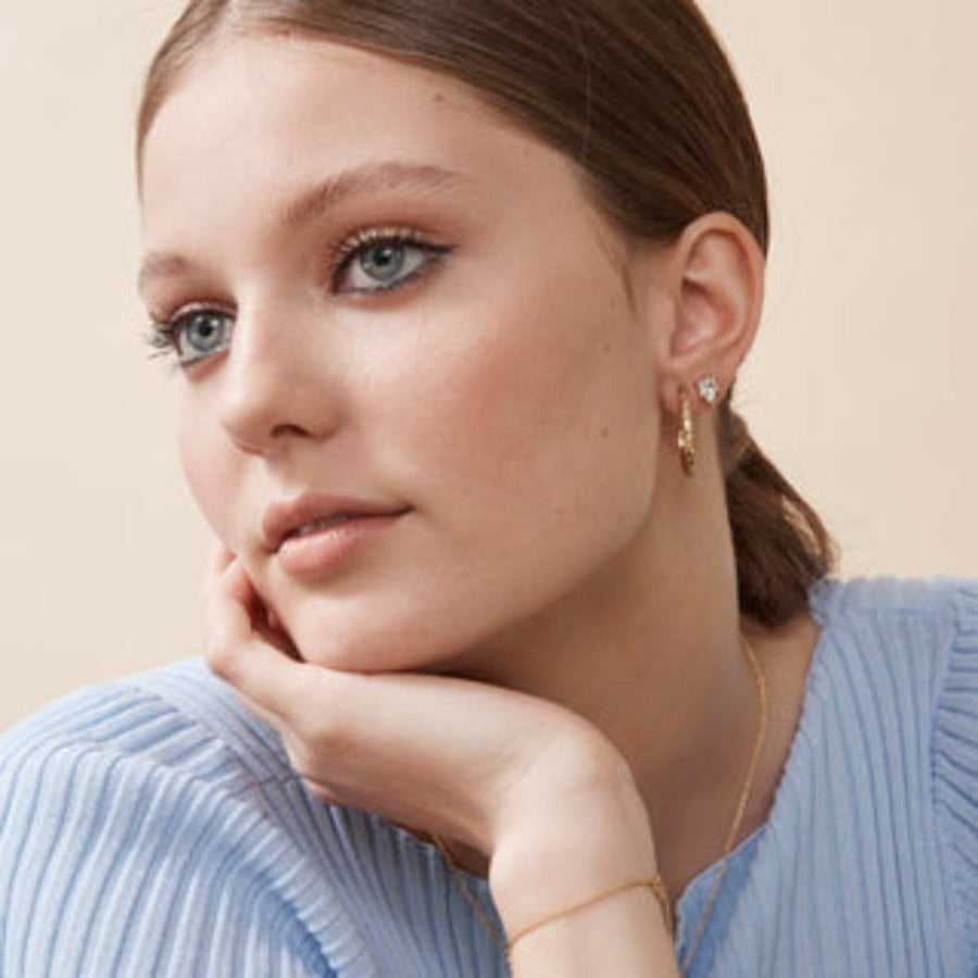 Model wearing the Alva studs with a blue sweater
