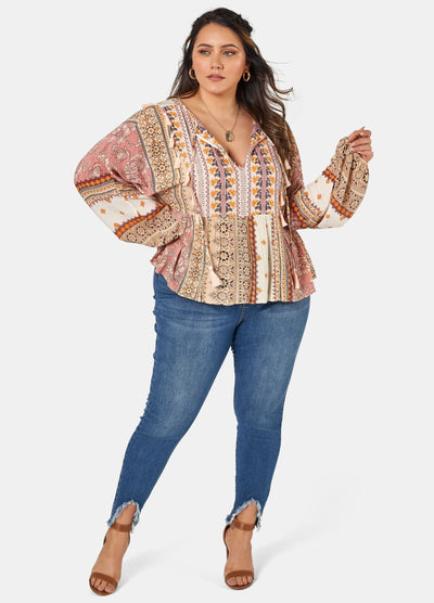 Woman wearing printed boho blouse with jeans
