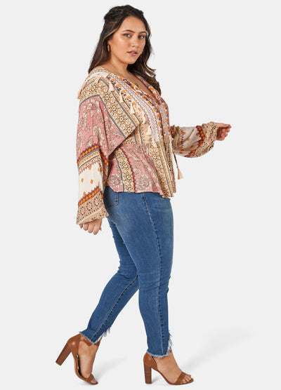 Woman wearing printed boho blouse with jeans