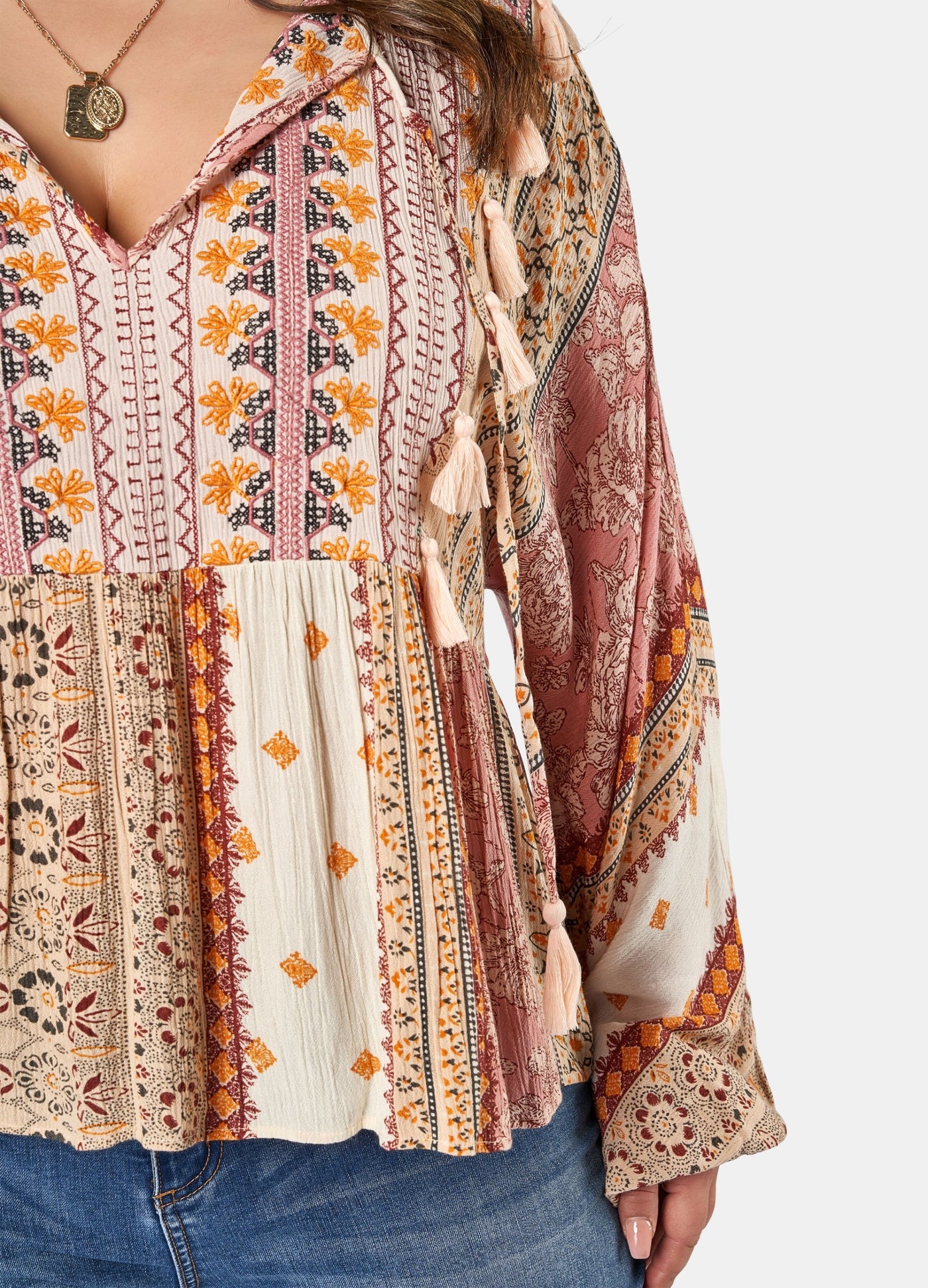 Woman wearing printed boho blouse with jeans