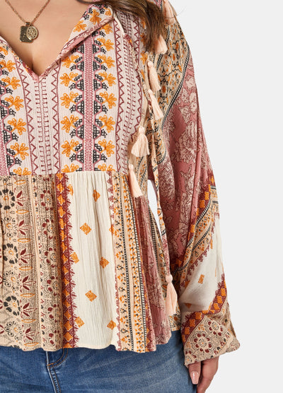 Woman wearing printed boho blouse with jeans