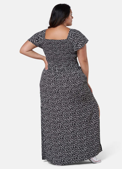 Woman wearing black and white print maxi dress
