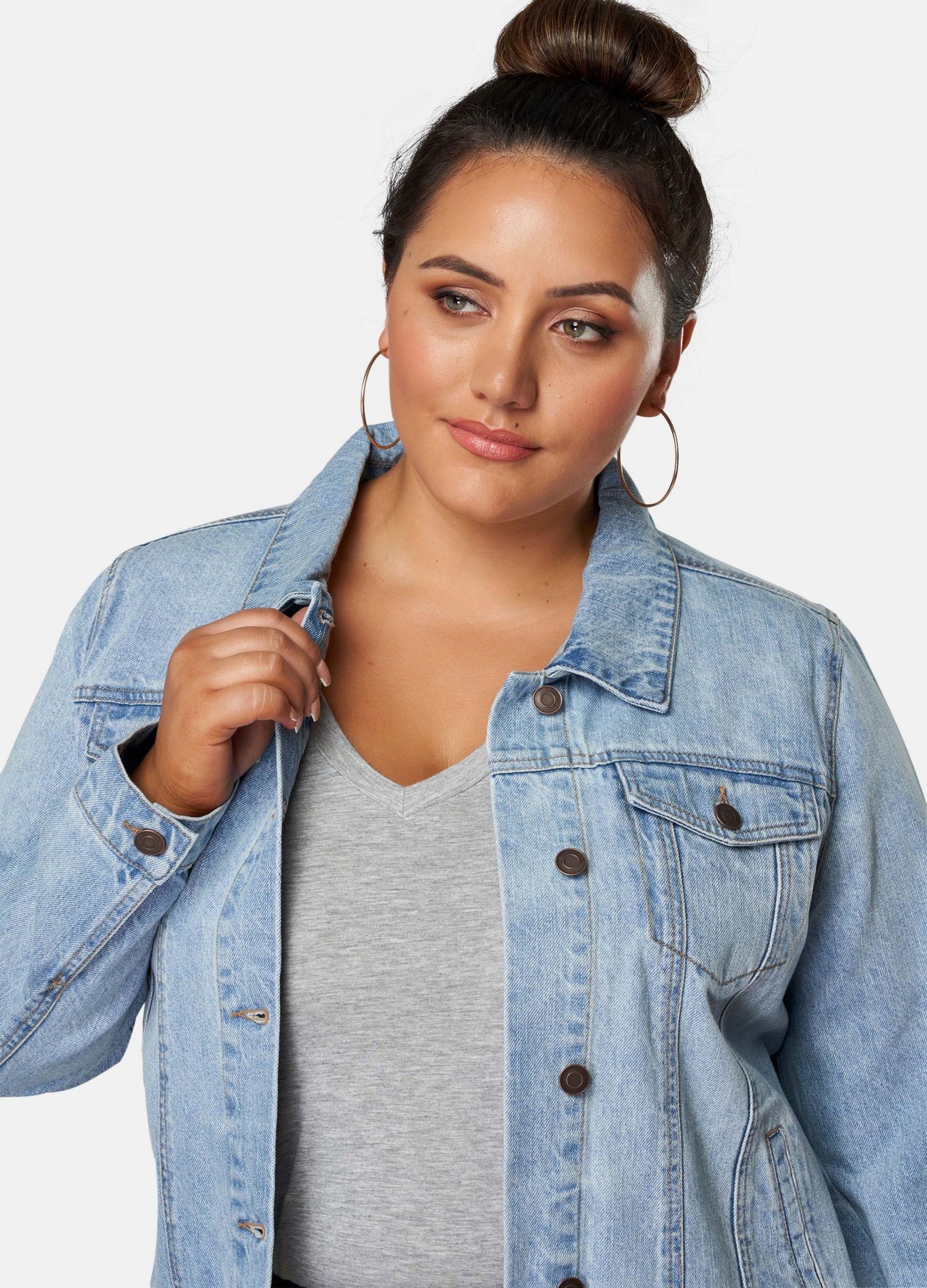Curvy Model wearing grey top and denim jacket