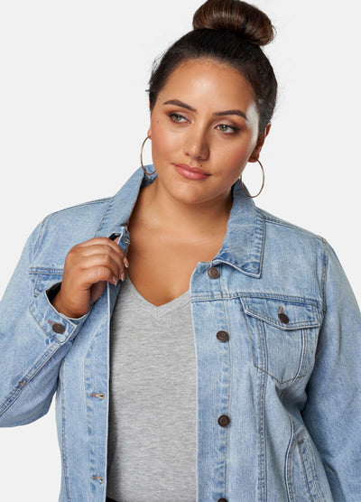 Curvy Model wearing grey top and denim jacket