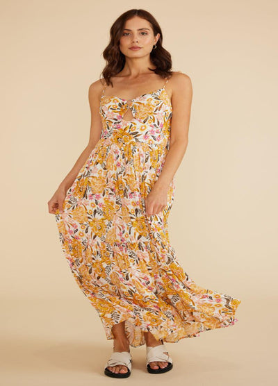 Model wearing the Ezra Dress in yellow floral print with keyhole cut out detail