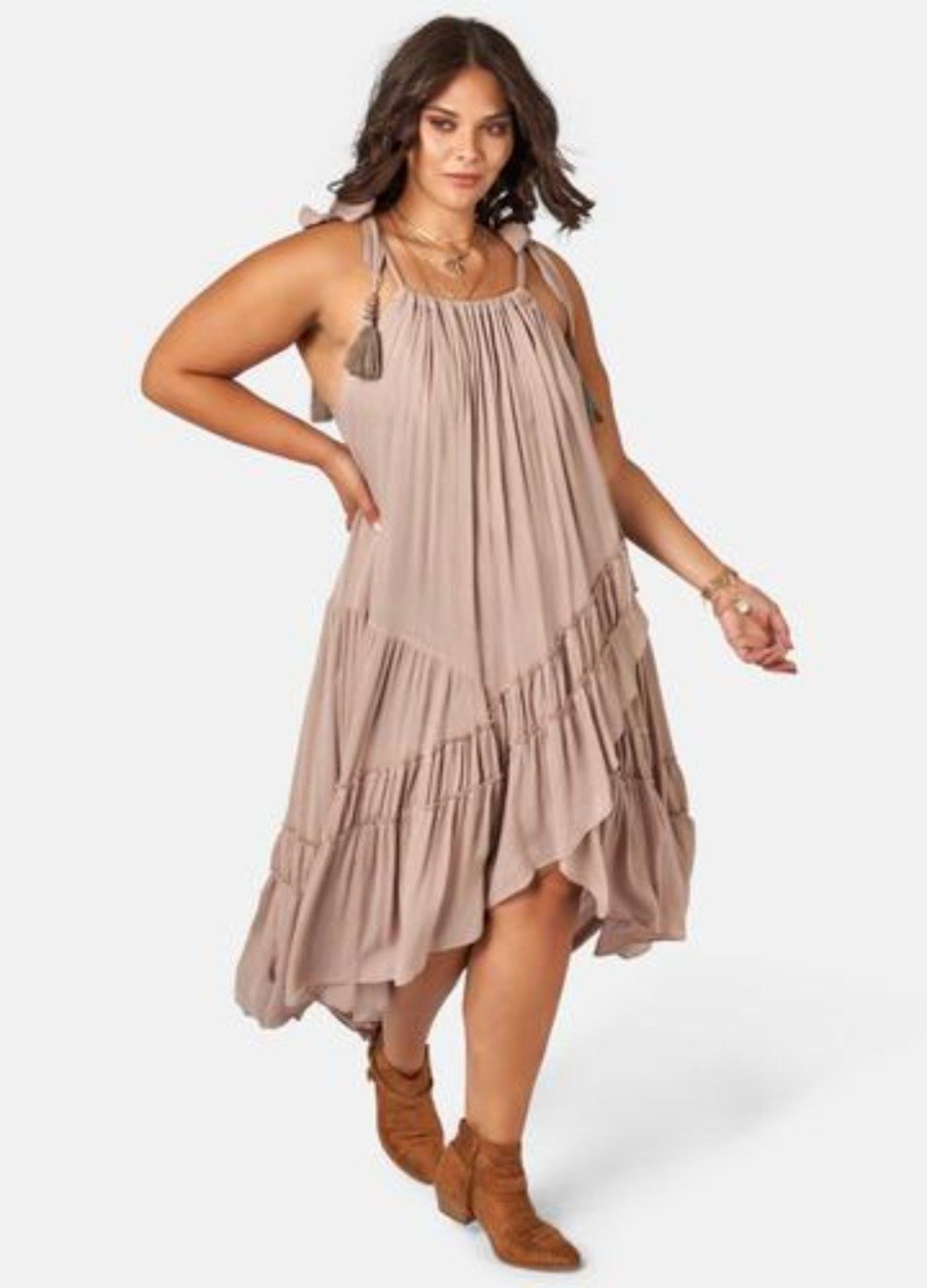 Model wearing nude maxi dress with asymmetric hemline