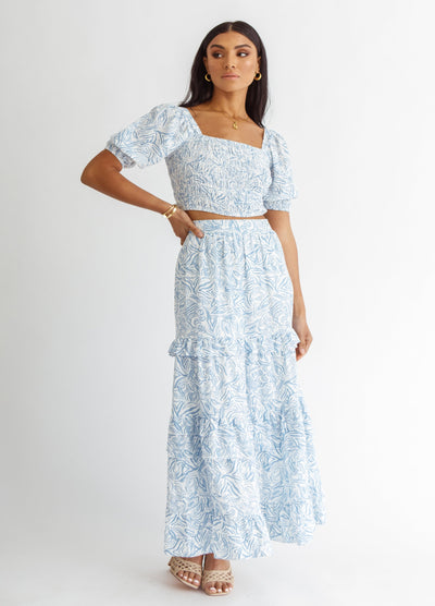 Woman wearing blue and white wave print top