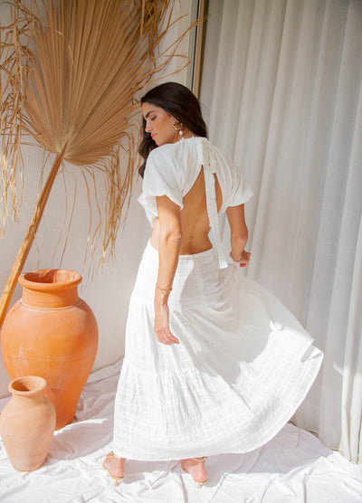 Woman wearing a white dress from back