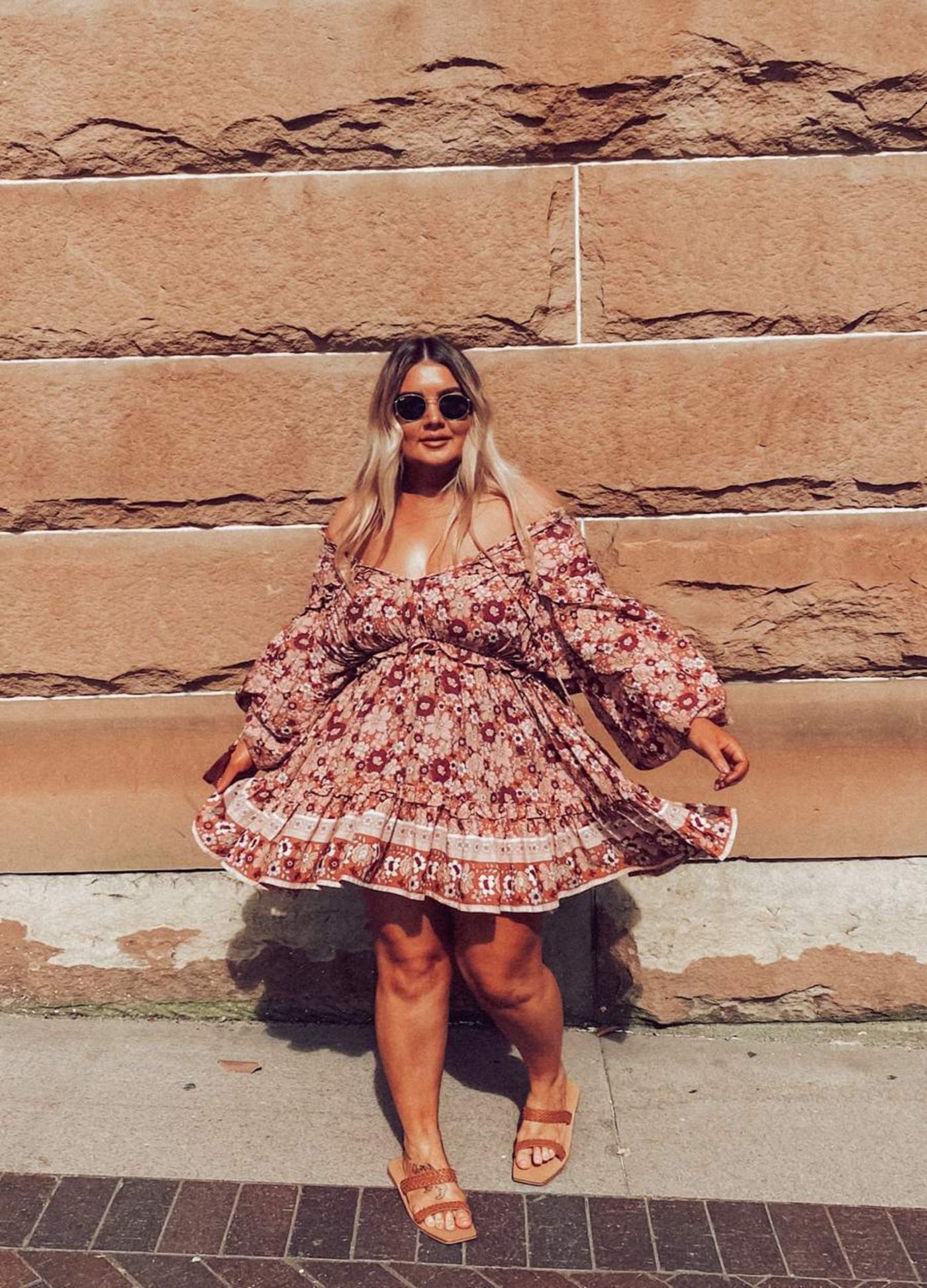 Curvy Woman in sunglasses wearing the Never Lost Mini Dress in Burgundy Print with tan sandals slightly off the shoulder