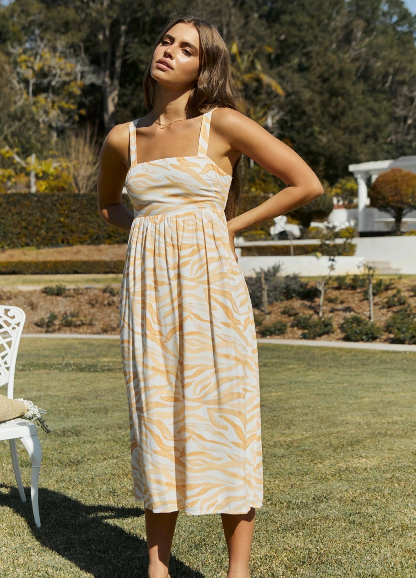 Model wearing the orange wave print dress