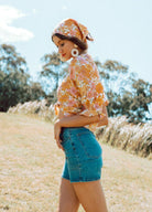 Woman wearing denim shorts in mid wash