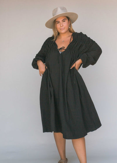 Woman wearing a black smock dress