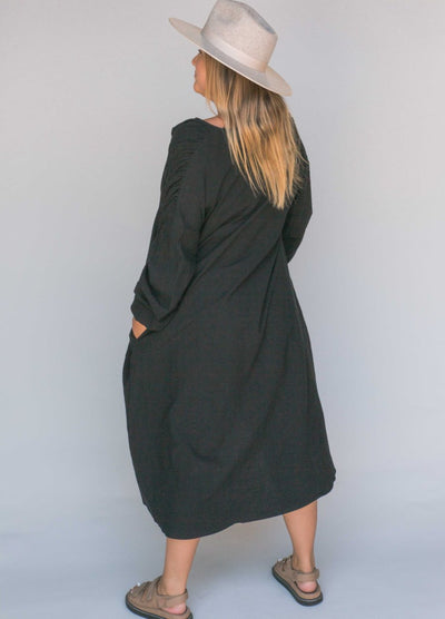 Woman wearing a black smock dress
