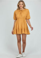 Blonde woman wearing yellow a line dress