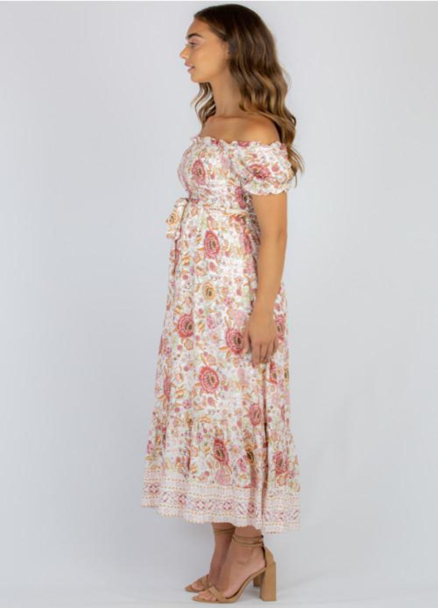 Model wearing floral maxi dress with nude colour heels from the size
