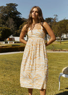 Model wearing the orange wave print dress